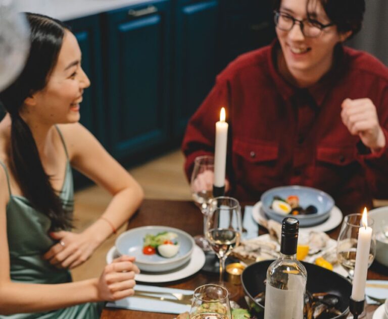 Friends laughing at a dinner party