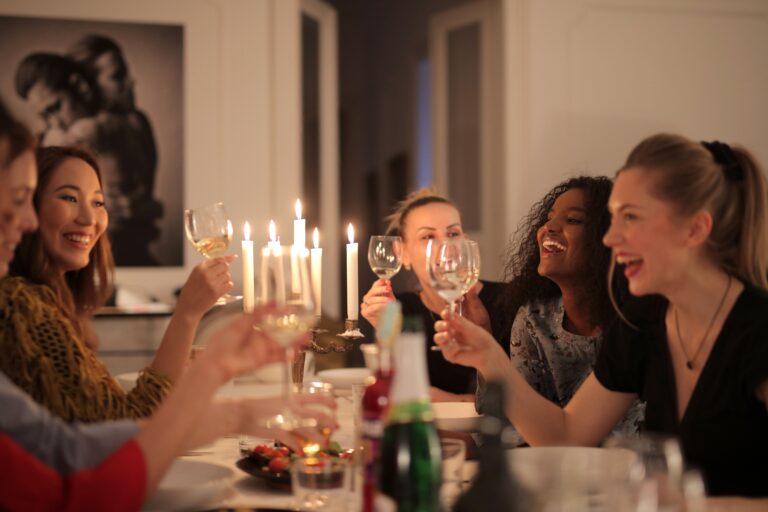 Friends laughing and chatting around a dinner table
